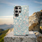 Pastel Meadow Floral Case – Soft Blue Background with Delicate Wildflowers